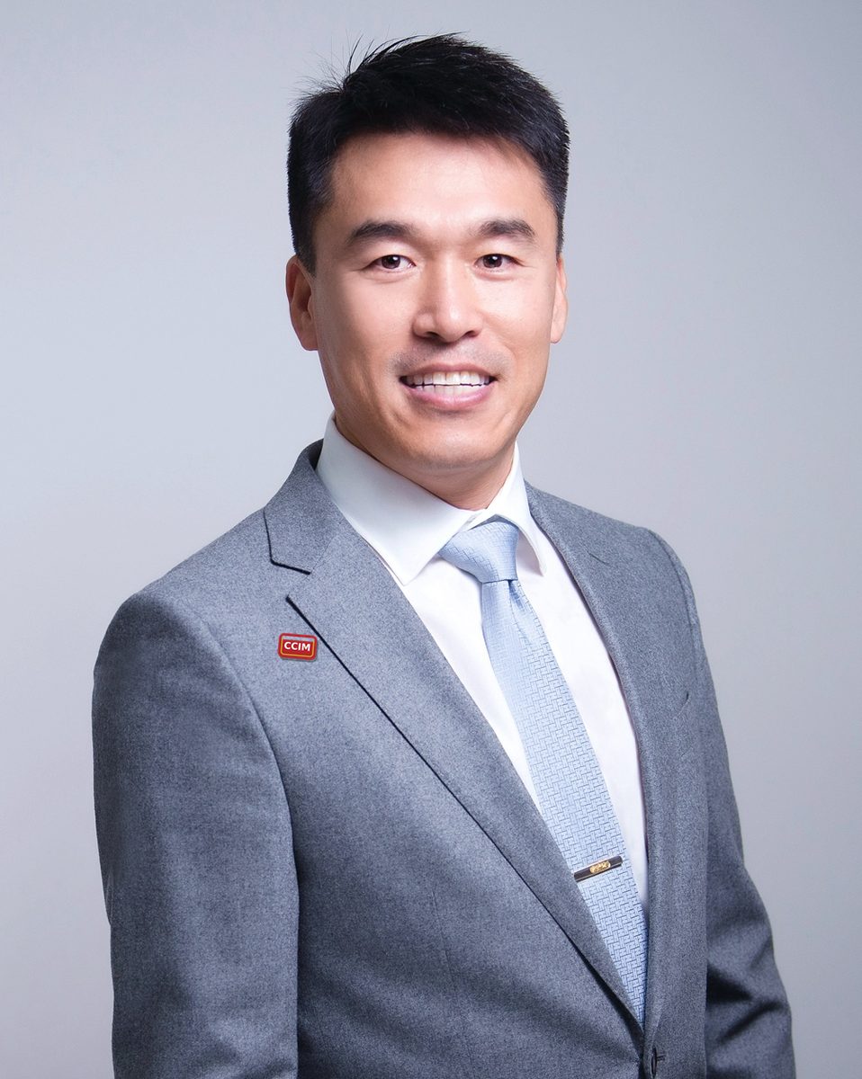 Jason Gao in a grey suit wearing a red CCIM pin